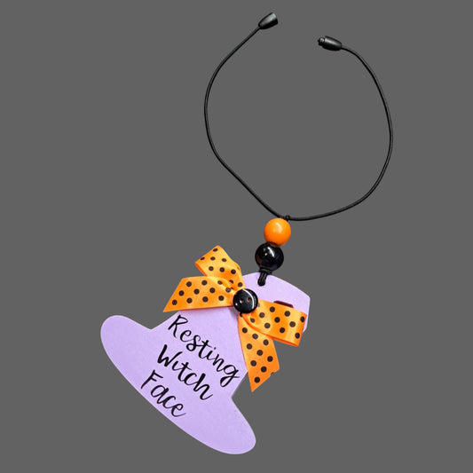 Resting Witch Face Car Mirror Charm – Purple/Orange/Black Polka Dot Bow